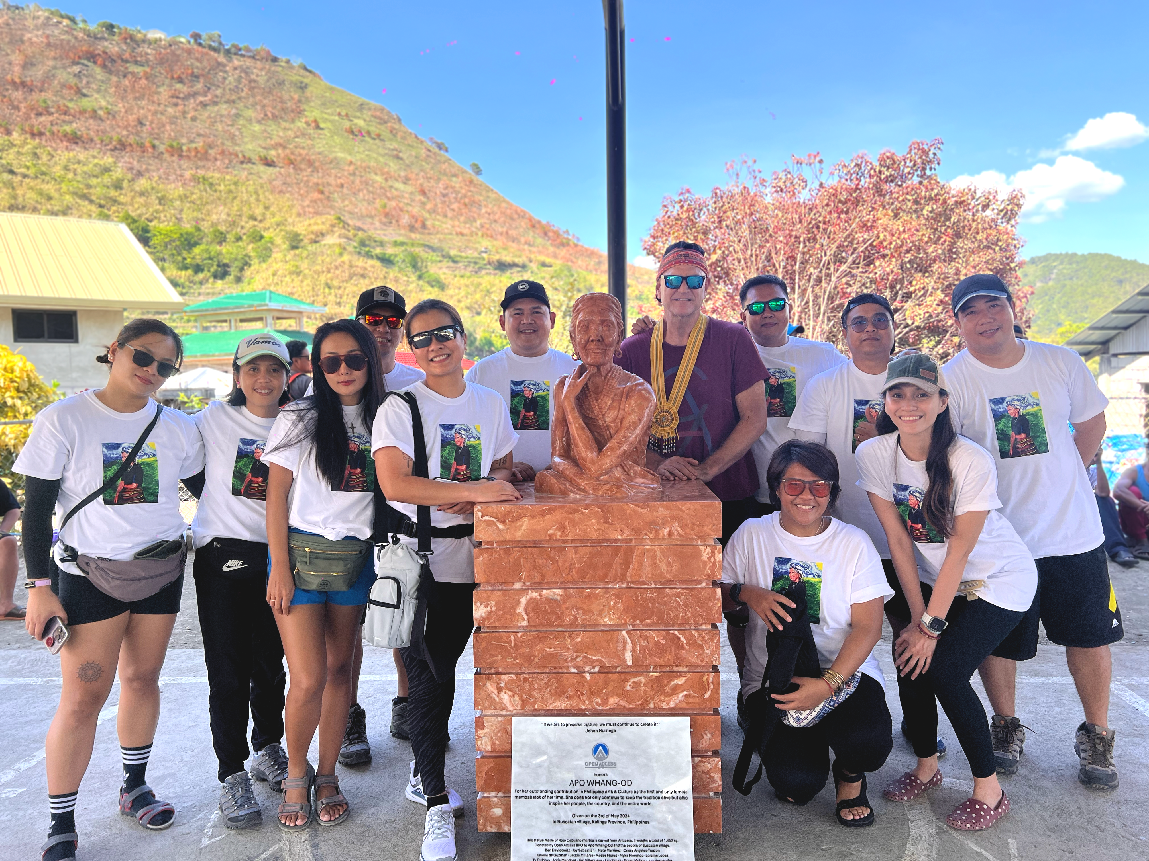 The Open Access BPO leadership team poses in front of Apo Whang-Od's bust