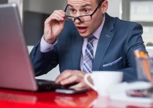 amazed-male-agent-looking-at-laptop