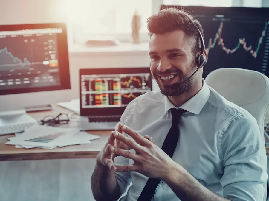 busy call center agent surrounded by graphs