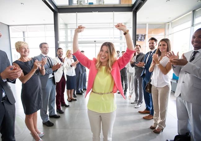 office employees applauding millennials coworker
