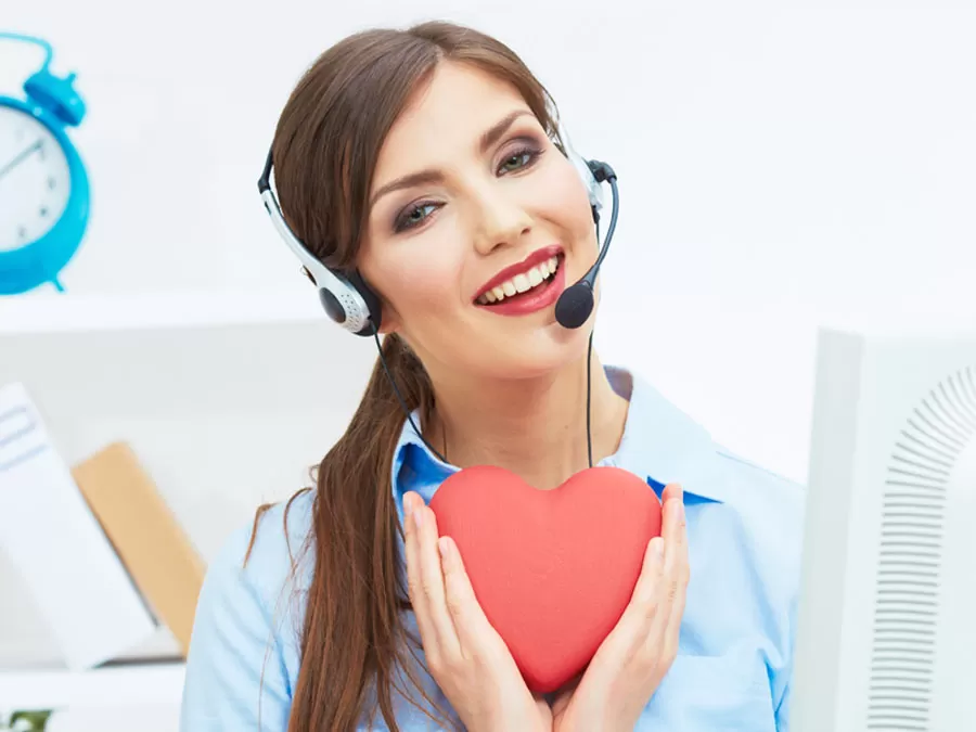 Smiling customer service agent holding heart