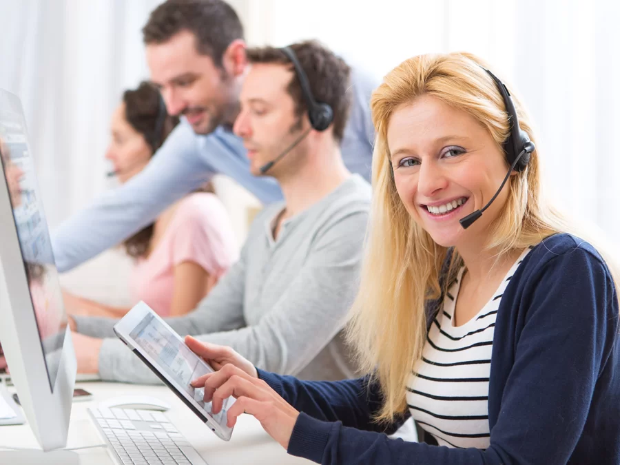 smiling call center agent using tablet