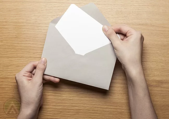 hands-taking-out-paper-from-envelope