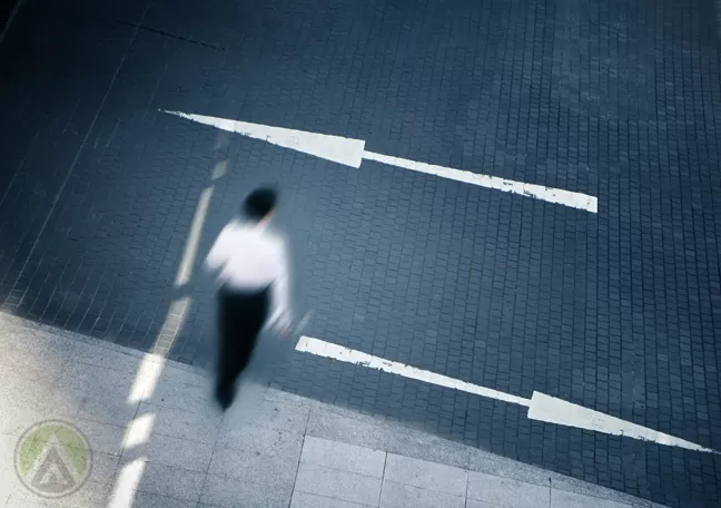 male-business-executive-in-white-crossing-the-street