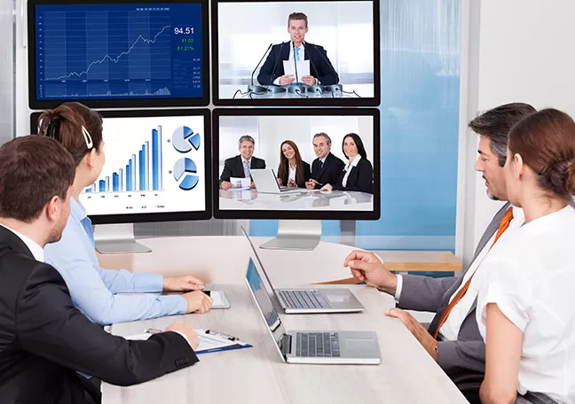 Business-people-holding-a-video-conference-on-multiple-screens