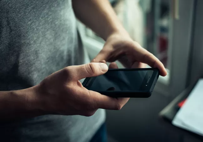 male-hands-holding-smartphone