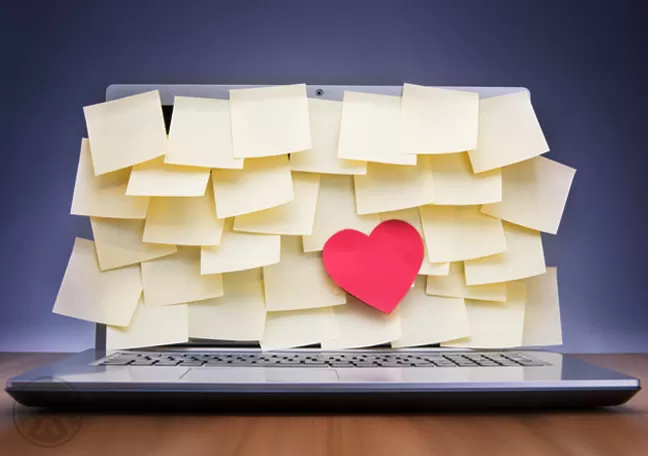 laptop-filled-with-post-it-noted-and-a-cutout-heart