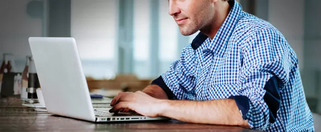 male-employee-studying-on-laptop