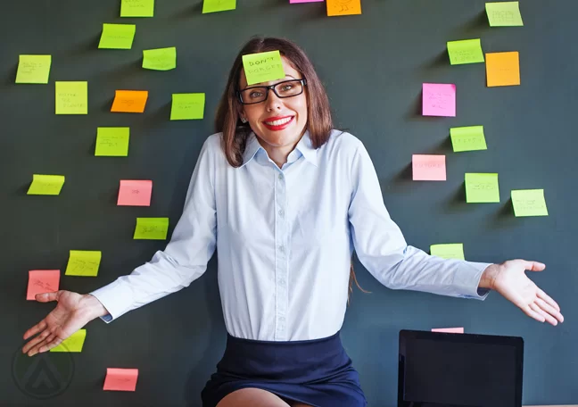 female-executive-covered-with-post-it-notes-shrugging-shoulder-apologetically