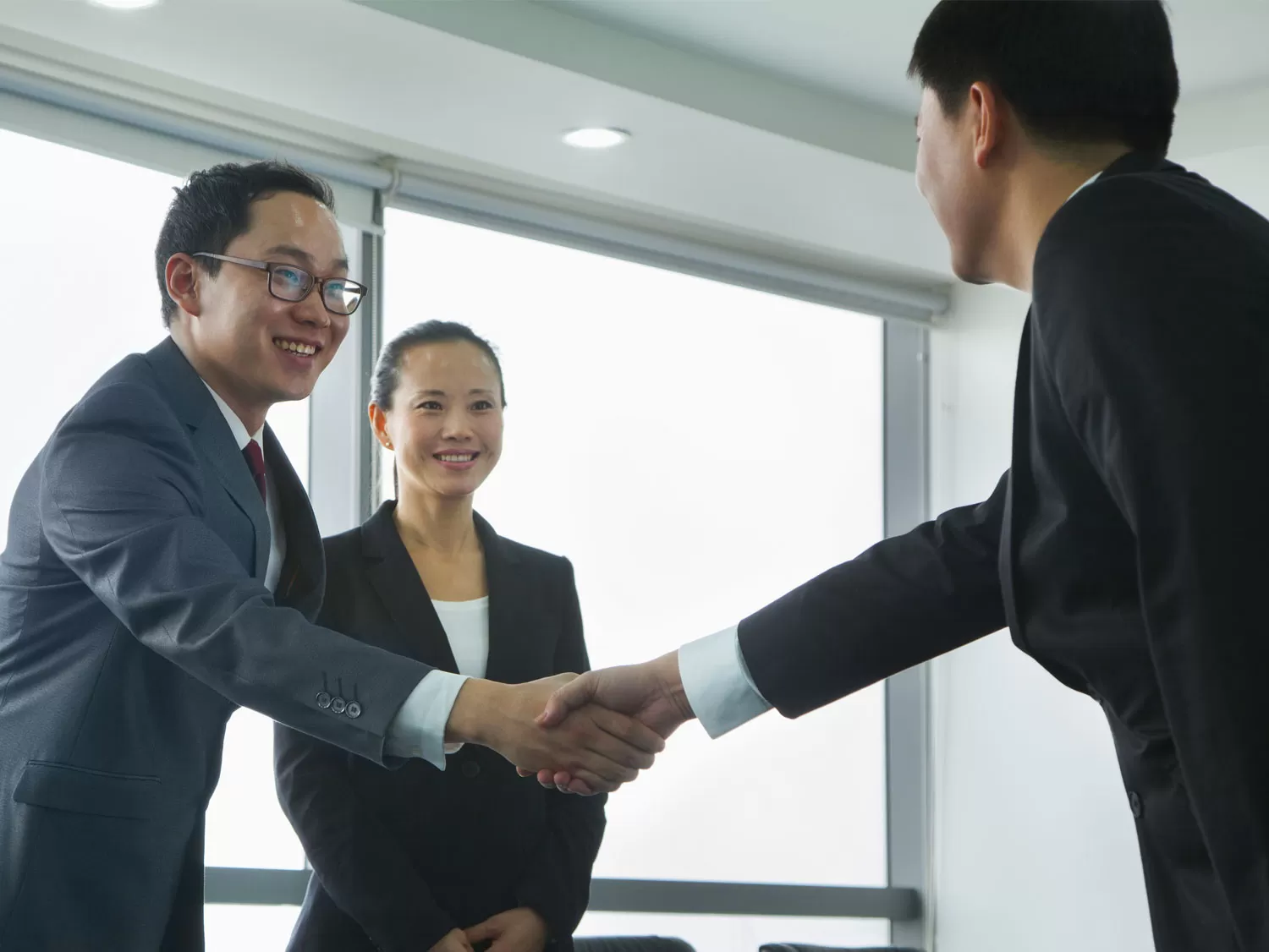 Chinese ecommerce distributor shaking hands with business executive
