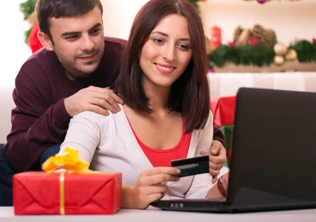 couple-by-laptop-holding-credit-card