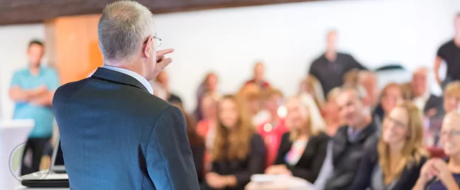 mature-businessman-dignitary-speaking-in-conference-hall