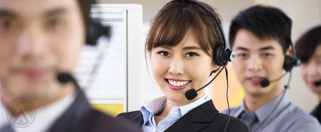 smiling-Asian-Filipino-call-center-agent-with-customer-service-coworkers