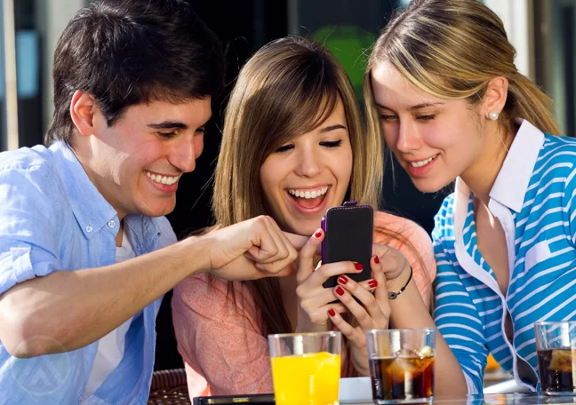 excited-group-young-friends-using-smartphone