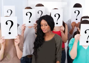 female-surrounded-by-people-with-question-marks