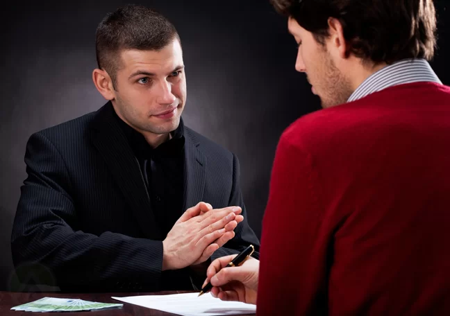 sneaky-businessman-watching-victim-sign-contract