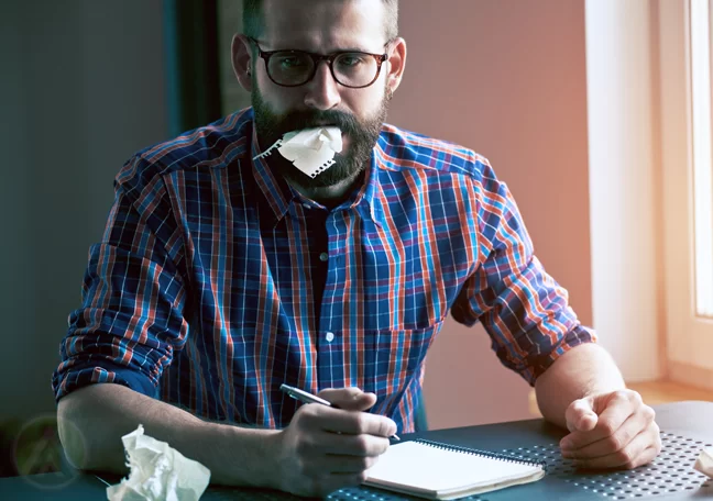 businessman-in-glasses-writing-on-notepad