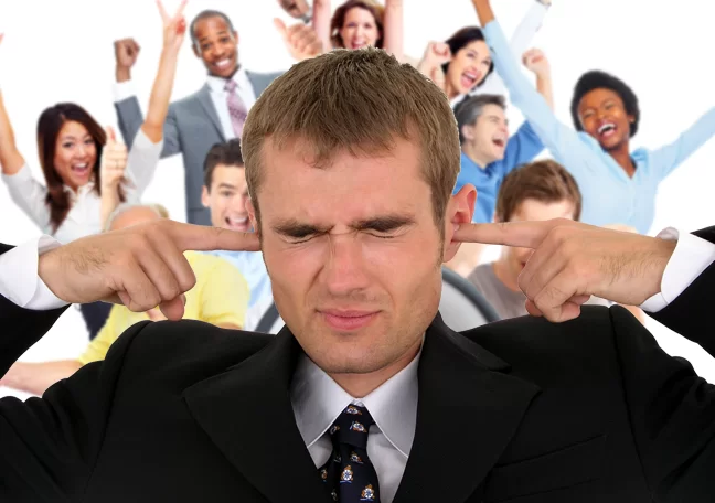 businessman-covering-ears-with-noisy-coworkers