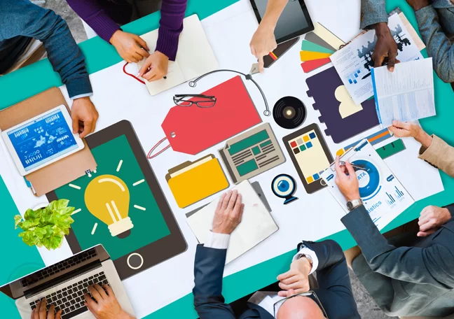 overview-shot-of-desk-of-laptops-with-digital-marketing-branding-icons