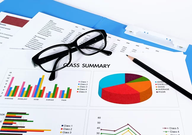 printed-business-graphs-and-charts-with-eye-glasses-pencil