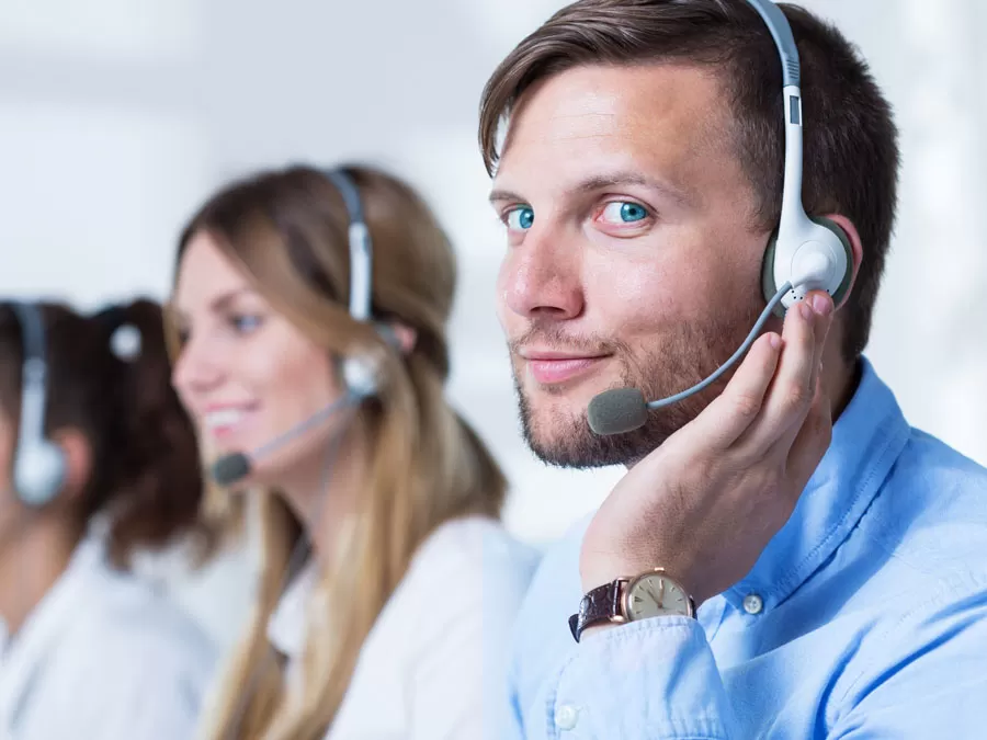 smiling call center agent working with customer support team