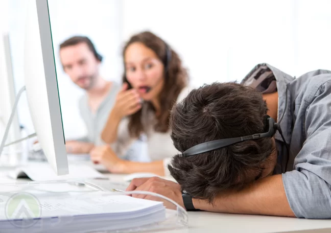 customer-service-agent-sleeping-at-work-with-shocked-call-center-coworkers