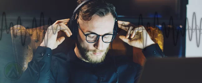 bearded-businessman-in-glasses-listening-to-headphones