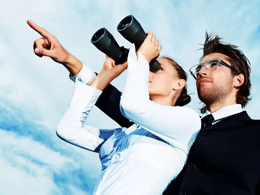 business partners looking through binoculars