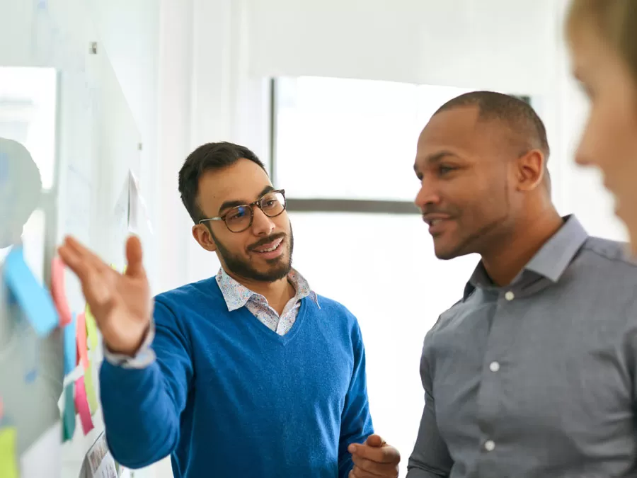 business executives discussing company matters on white board