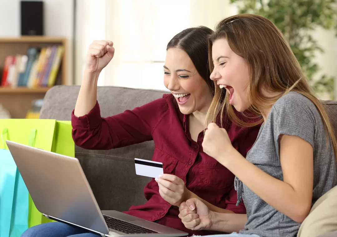 measure customer loyalty depiction excited women shopping online on laptop