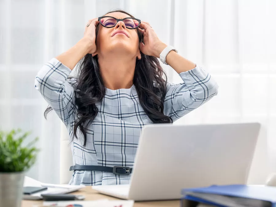 frustrated customer service agent holding head in headache