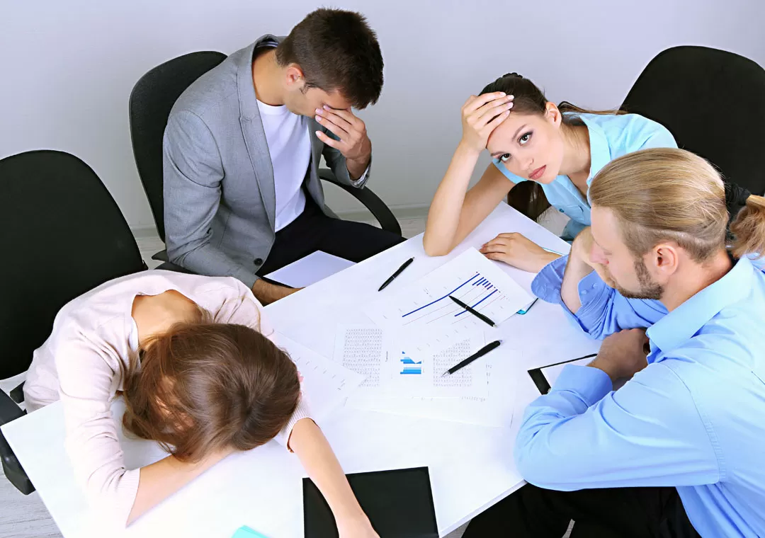 bored sleepy demotivated sad business team in a meeting