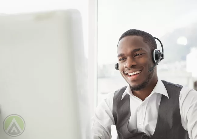 call center representative talking to customer in front of computer