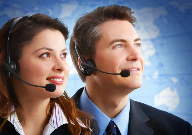 male female call center agents looking away world map in background