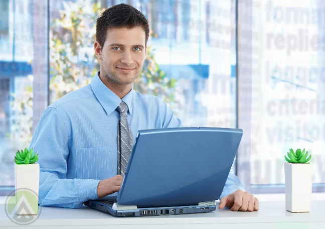 businessman in blue using laptop in coffee shop