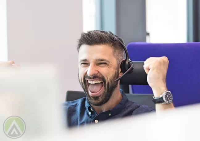 excited male call center agent fists in air