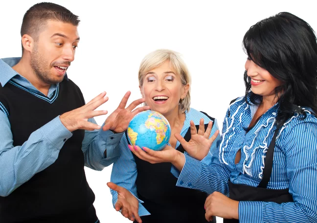 office workers delighted looking at small globe