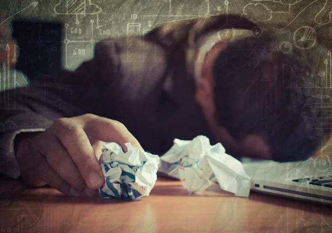 buried face problematic businessman holding crumpled paper