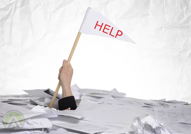 businessman drowning in paper holding up help white flag