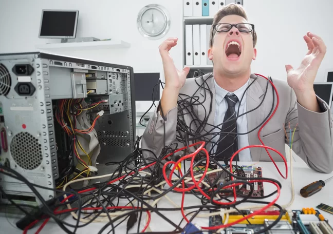 screaming tech worker in office fixing computer
