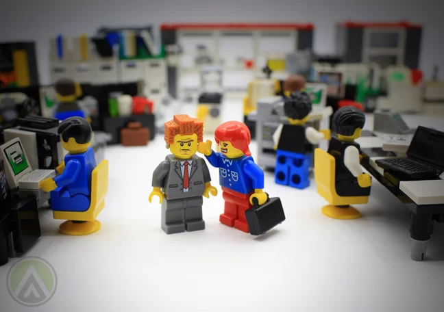 annoyed boss energetic employee lego minifigs in office 