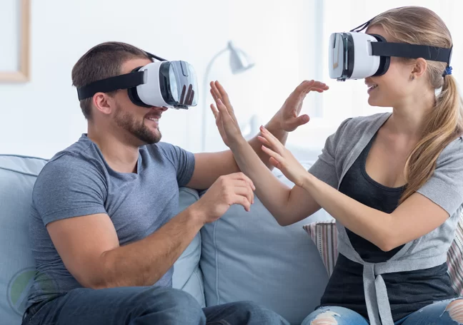 couple playing in couch wearing virtual reality vr glasses