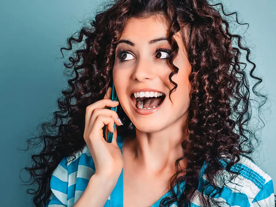 delightful excited woman speaking to customer service agent on the phone