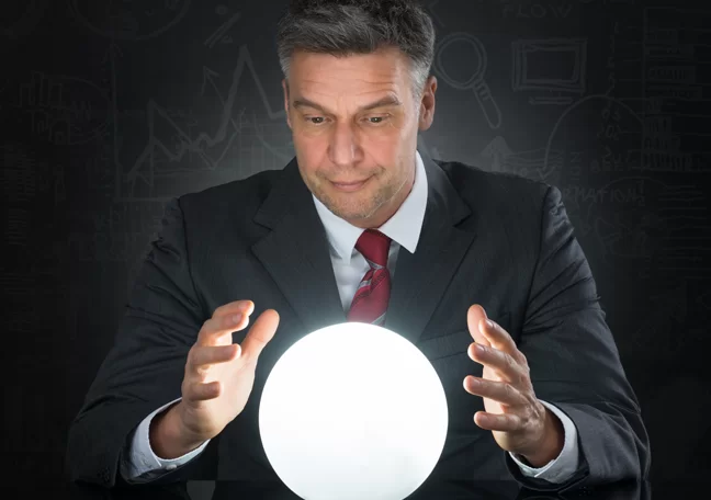 fortune teller businessman looking into crystal ball