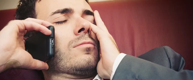 businessman asleep making phone call