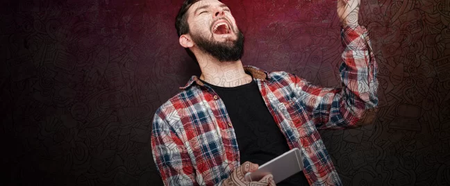 man holding smartphone with evil laugh