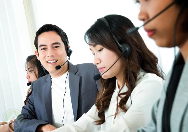 smiling call center agent with customer service team