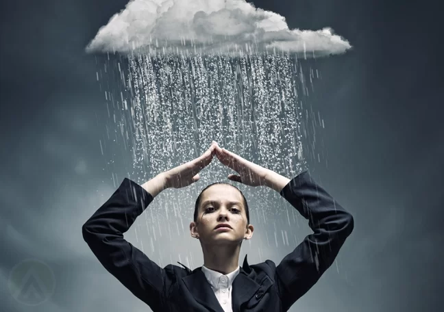 successful business woman shielding self from rain from dark cloud