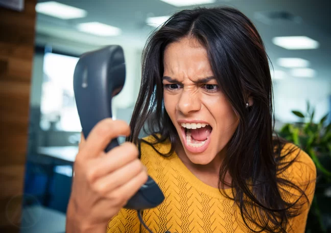 woman scraming at telephone