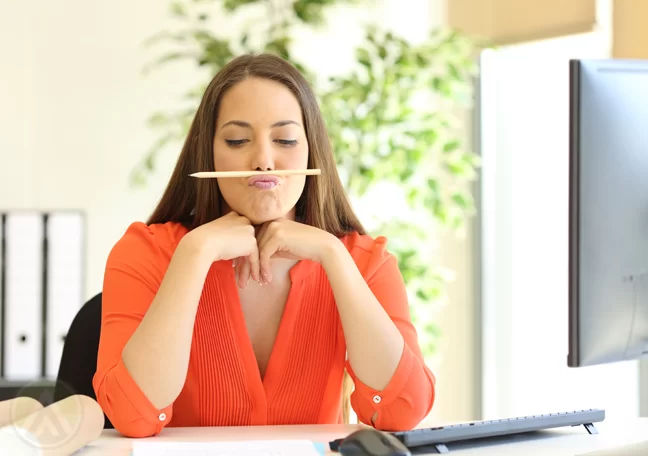 bored office worker playing with pencil on mouth